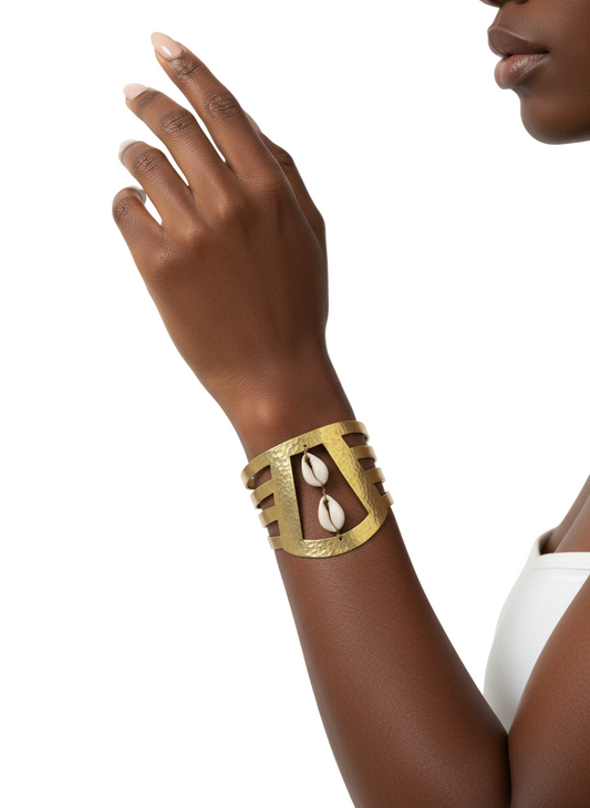 Gold bracelet on a wrist with a plain background