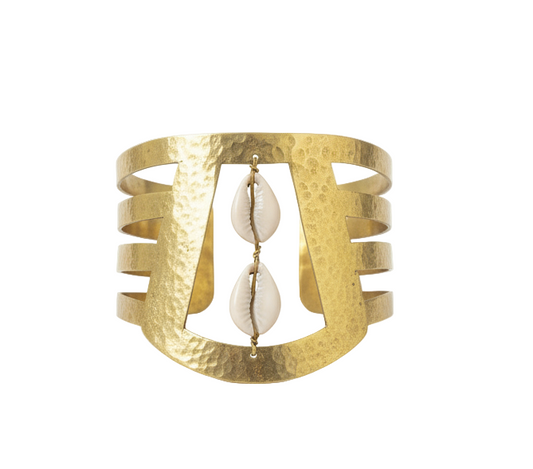 Gold cuff bracelet with a central pearl on a white background
