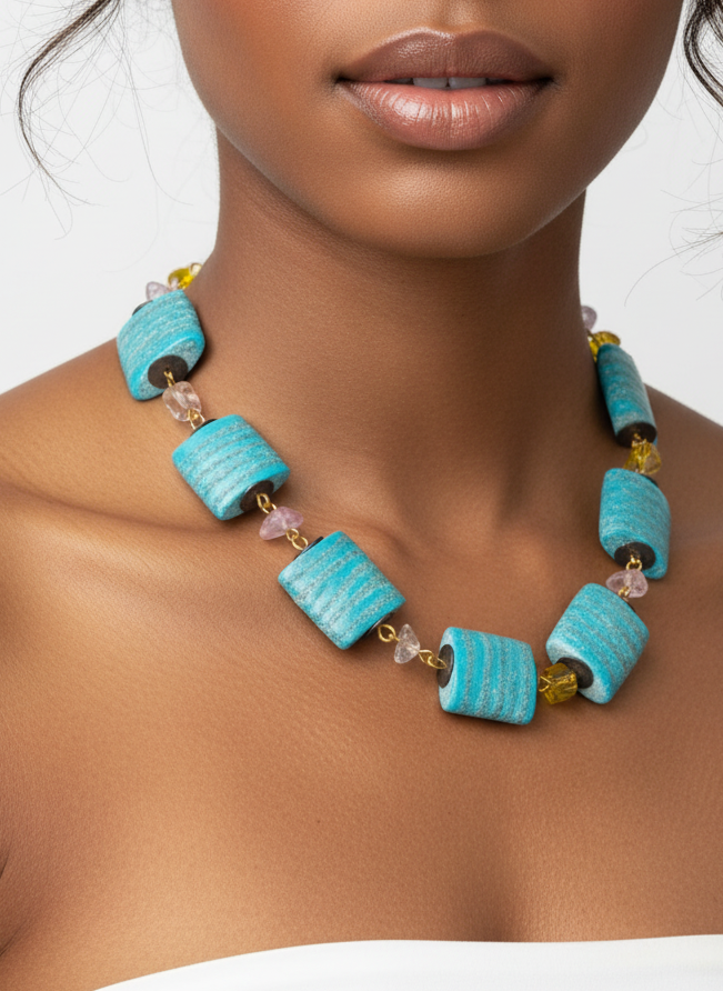 Woman wearing a turquoise necklace against a neutral background