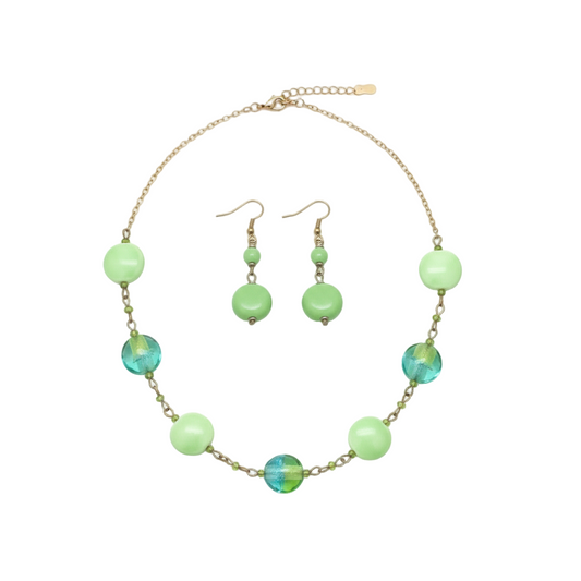 Necklace and earrings set with green beads on a white background